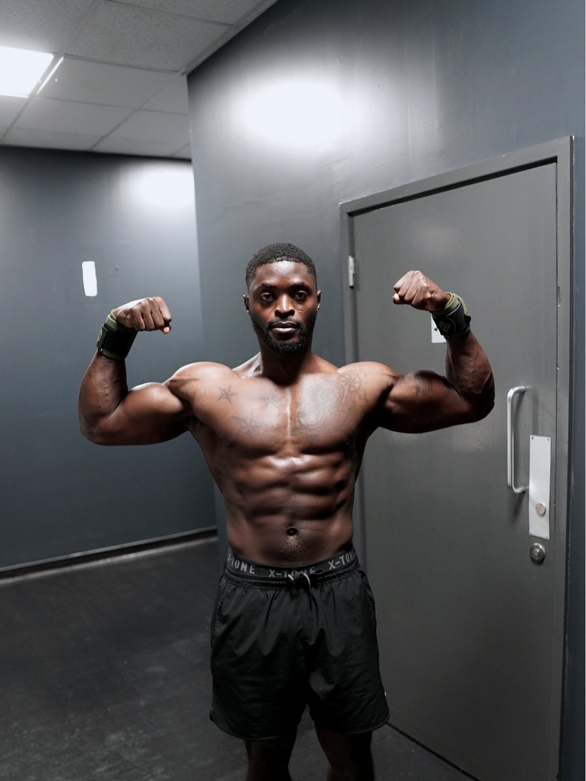 Franklyn Nez holding a front double biceps pose in the gym